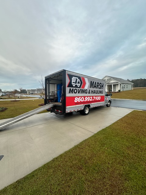Yellow moving truck with the Marsh brand name